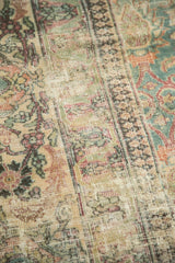Distressed texture revealing muted floral patterns and foundation on antique Khorassan rug.
