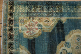 Vintage Hamadan rug corner showing abrashed blue, ivory, gold field with rococo border.