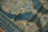Vintage Hamadan rug close-up: abrashed indigo field, worn rococo outlines, visible foundation.