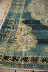 Vintage Hamadan rug, faded denim field, rococo gold outline, and patterned border.