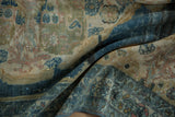 Folded vintage Hamadan rug with faded denim blue border, abrashed gold field, and wear.