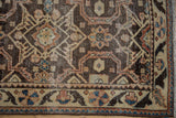 Hamadan runner corner: dark brown, beige, blue, chestnut geometric patterns, fringe.