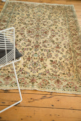Vintage Kerman rug corner, detailed floral border, fringe, and even ivory pile.