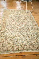 Vintage Kerman rug border with ivory, blue, green, and raspberry floral designs.