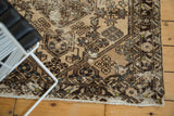 Distressed corner of vintage Hamadan rug, revealing foundation, floral bouquets, and dusty blue highlights.