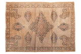 Antique Doroksh rug, oversize Mil Fleur medallion, intricate paisley in aged sand, dusty blue, and camel tones.