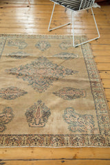 Antique Doroksh rug's faded field showing dusty blue Mil Fleur and paisley motifs.