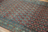 Vintage Serbend runner's staggered dusty raspberry boteh and aqua geometric border, with visible wear.