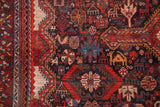 Densely arranged antique Qashqai patterns, featuring tribal animals, geometric border, wine red and navy.