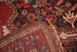 Secured side binding, natural fringe, and dense hand-knotting on the Qashqai rug's reverse.