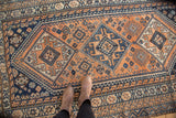 Vintage Kamseh rug, apricot and navy triple diamond medallions, with even wear.