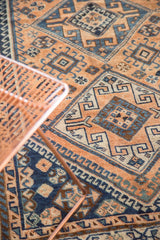 Apricot, navy, and sky blue pinwheel and ram's horn motifs on vintage Kamseh rug.