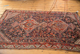 Double medallion and intricate field of an antique Qashqai rug with madder red, navy, ivory patterns.