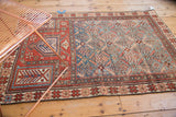 Antique Caucasian prayer rug's geometric pinwheel and lattice motifs in sky blue, madder red.