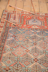 Antique Caucasian rug with lattice design, germinating plants, serrated leaves in blue and red.