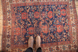 Antique Afshar rug with staggered cherry red and navy motifs, showcasing mostly even wear.