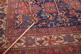 Detailed section of the antique Afshar rug, showcasing tribal patterns in navy, cherry red, and softened ivory, with characteristic wear.