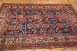 Intricate geometric border of the antique Afshar rug, displaying time-softened tones and visible pile wear.