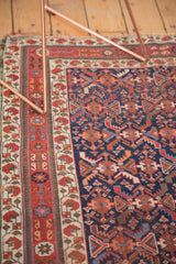 Antique Afshar indigo ground with geometric herati. Ivory border shows red boteh, aged texture.