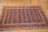 Antique Afshar rug border showing diminutive boteh, pomegranate motifs in cherry red, ivory.