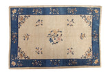Antique Chinese Peking carpet: beige field, cobalt blue border, art deco floral vinery, circa 1910s.