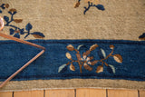 Delicate blossomed floral vinery on the cobalt blue border and antique beige field.