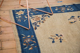 Art deco stylized Peking carpet detail: delicate vinery on cobalt blue border and beige field.