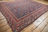 Hand-knotted antique Afshar rug's geometric border detail in pomegranate red and deep navy.