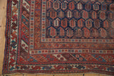 Antique Persian Afshar corner detail, showcasing geometric borders and navy boteh field.