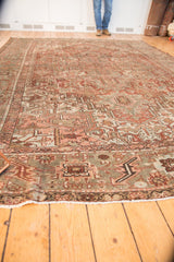 Distressed vintage Karaja carpet's low pile, fringed edge, and rectilinear motifs in bronze, slate, and beige.