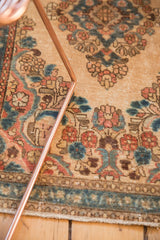 Distressed vintage Kazvin runner with faded floral motifs in beige, blue, and red.