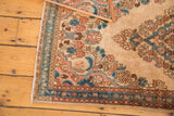 Detail of Vintage Distressed Kazvin rug corner, showing floral bouquets, scrolling vinery in muted tones.