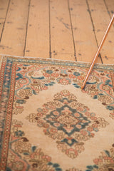 Distressed vintage Kazvin runner with soft beige field, sky blue, apricot floral vinery.