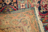 Antique Kerman carpet's hand-knotted foundation, with an end showing partial tatter.