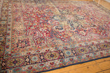 Detailed mil fleur design and floral border of an antique Persian Kerman carpet.