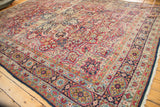 Antique Kerman carpet: Mil fleur field detail, multi-layered floral border in cherry red, navy, powder blue.
