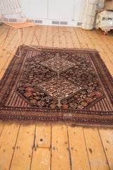 Antique Kamseh rug's light tatter, brick red and navy geometric border.