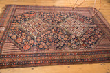 Geometric animals, diamonds, pomegranates, and low pile on this Antique Kamseh rug.