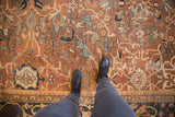 Antique Mahal carpet, chocolate bronze field with oversized motifs, shown with boots.
