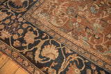 Antique Mahal carpet detail: navy border, chocolate bronze field, stylized floral patterns and storied wear.