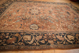 Antique Mahal carpet's navy border with oversized floral motifs merging into the chocolate bronze field.