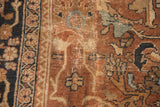 Antique Mahal carpet detail, showcasing visible wear, storied mending, and bronze, navy motifs.