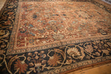 Antique Mahal carpet corner detail with navy blue border and chocolate bronze field with stylized floral motifs.