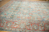 Distressed Mahal carpet with worn pile, soft blue and cranberry floral patterns, and subtle abrashes.