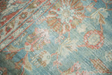 Textured pile of distressed Mahal carpet featuring sky blue and pale cranberry floral designs.