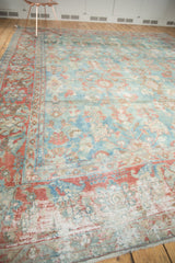 Worn floral patterns in cranberry, sky blue, and ivory on a distressed Mahal rug, foundation visible.