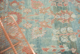 Distressed vintage Mahal rug detail: sea foam blue field with faded cranberry florals.