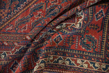 Excellent contrast in the cherry red and indigo tribal motifs of a softly folded Afshar carpet.