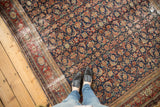 Distressed border and field detail of antique Malayer carpet, featuring indigo, red herati motif.