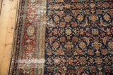 Intricate herati mahi motif on distressed fine antique Malayer rug, with indigo, wine red, and bronze tones.